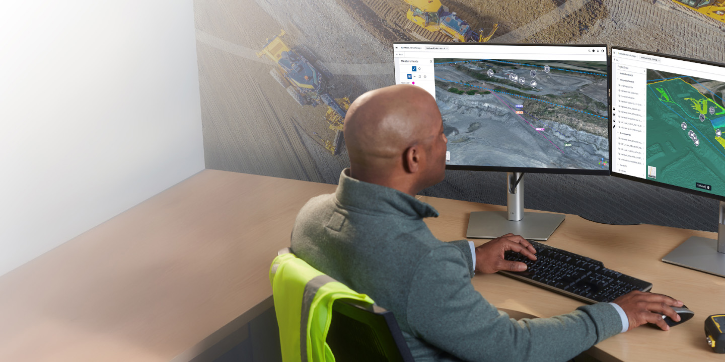 Construction worker on site using Trimble Site Management software for field to office connectivity