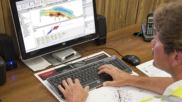 Desktop monitor displaying a Trimble Business Center software model for a roading project