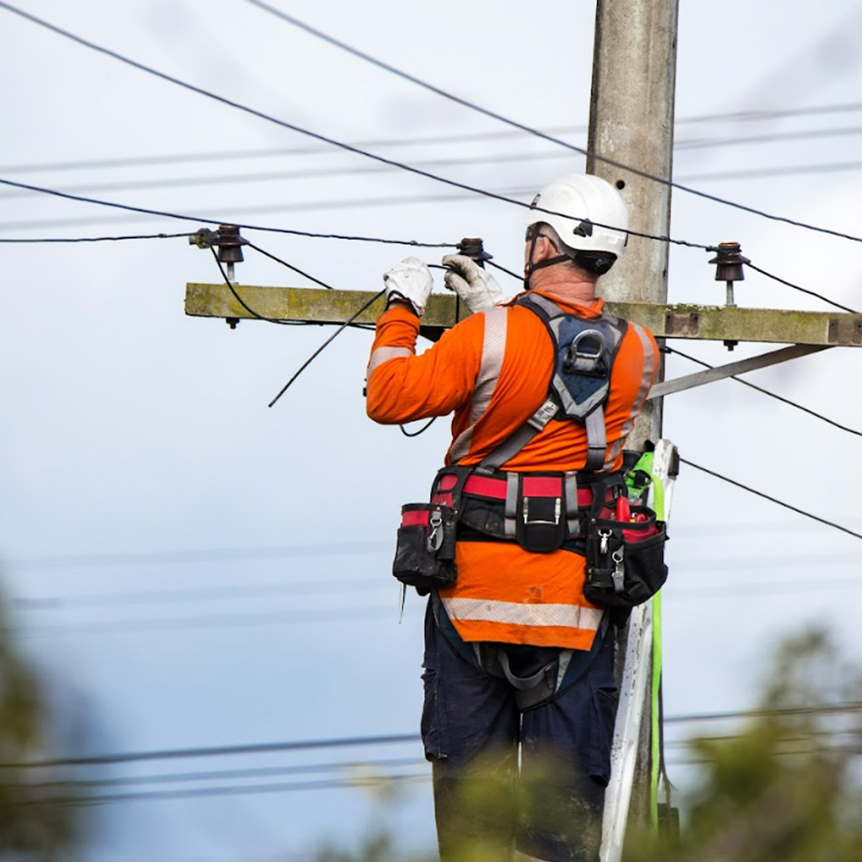 A telecommunciations engineer repairing telecom lines.