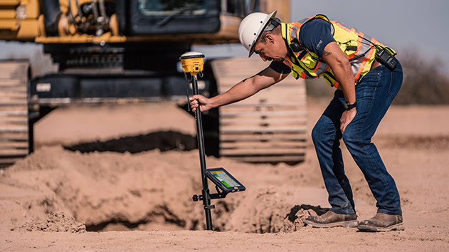 Trimble Siteworks SPS986 GNSS smart antenna and T100 tablet being used to verify ground levels on a construction site