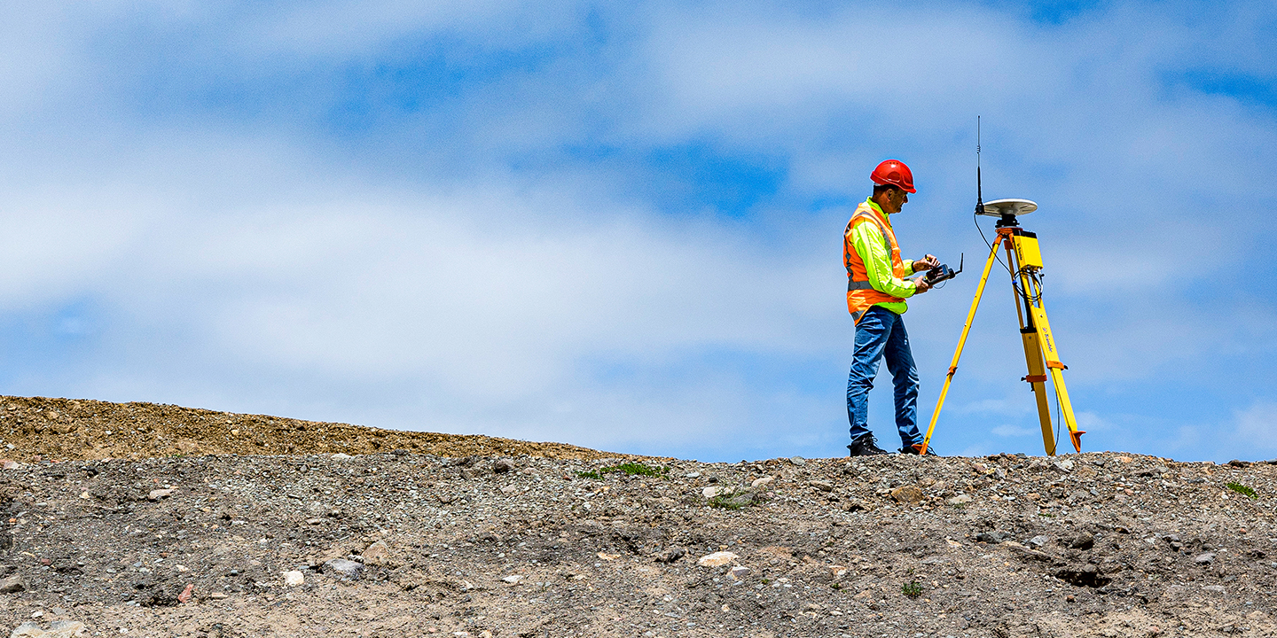 Surveyor using Trimble R750 GNSS Modular Receiver with TSC7 Controller on construction site