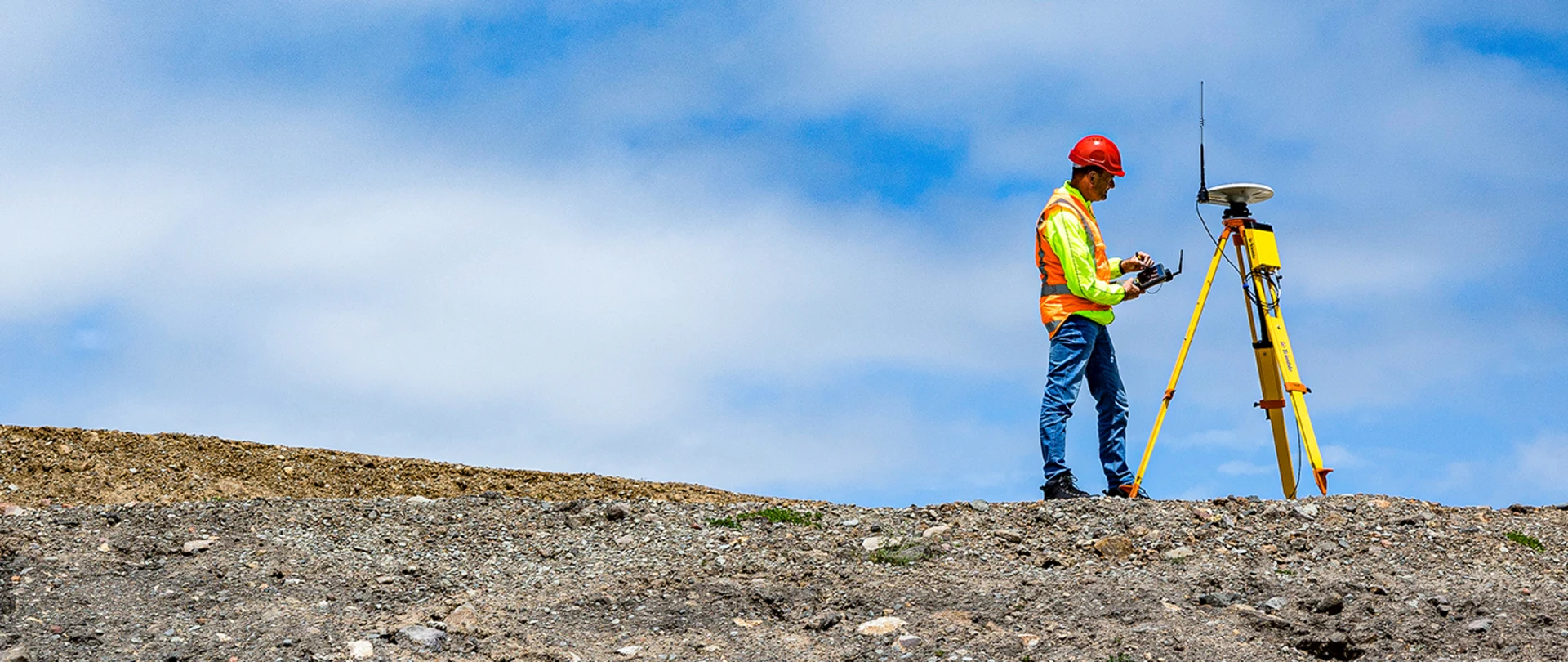 Surveyor using Trimble R750 GNSS Modular Receiver with TSC7 Controller on construction site