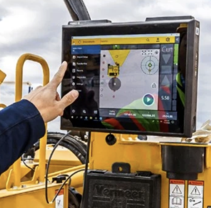 Man using Trimble Groundworks system while on a drilling machine