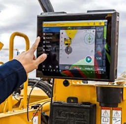 Man using Trimble Groundworks system while on a drilling machine