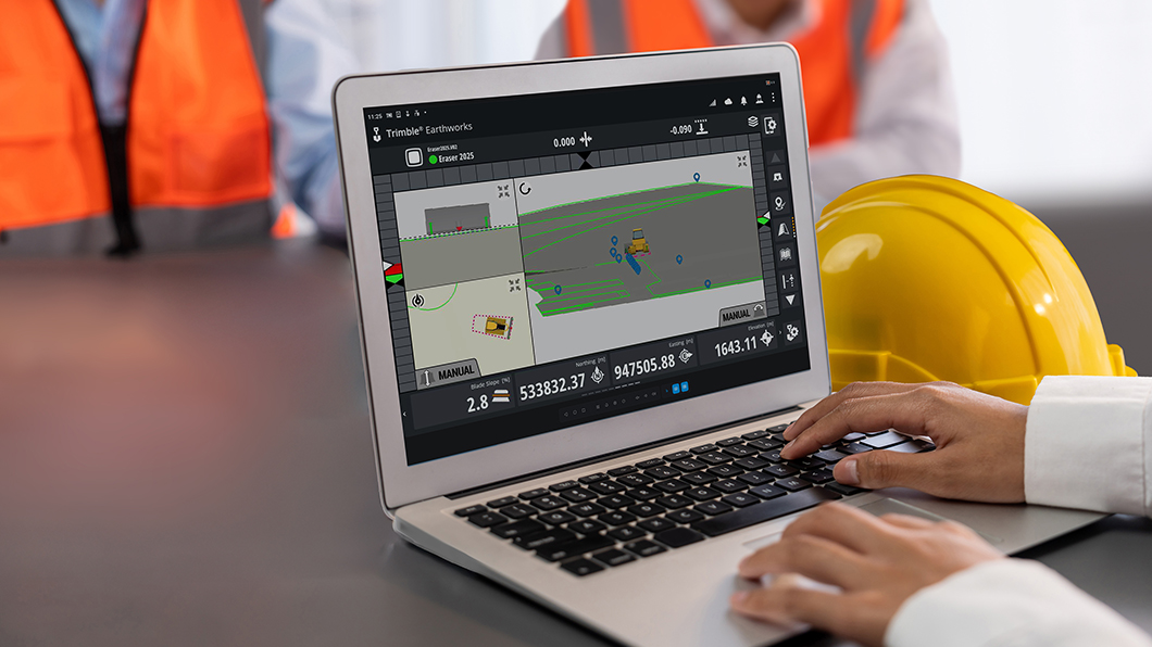 Construction site manager in office using ScreenView to view and control Trimble Earthworks remotely