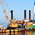 Successful in-harbor marine dredging operation with two cranes on a floating dredging platform