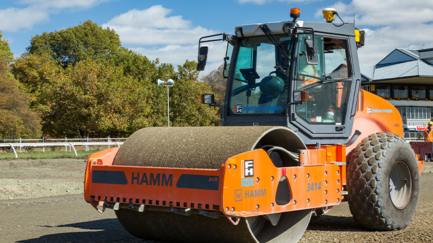HAMM soil compactor with Trimble Earthworks, compacting dirt surface on construction site