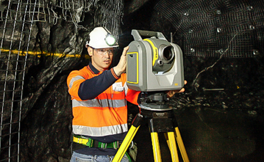 Mining worker in underground tunnel with a Trimble SX12