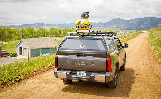 Trimble MX60 mobile mapping system mounted on a moving car's roof