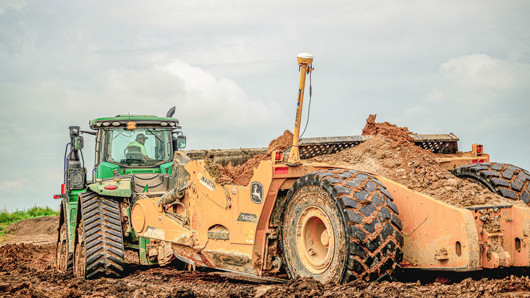 Towed scraper moving around a jobsite
