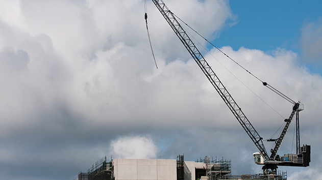 Sling on a construction crane blowing in high winds on a building site