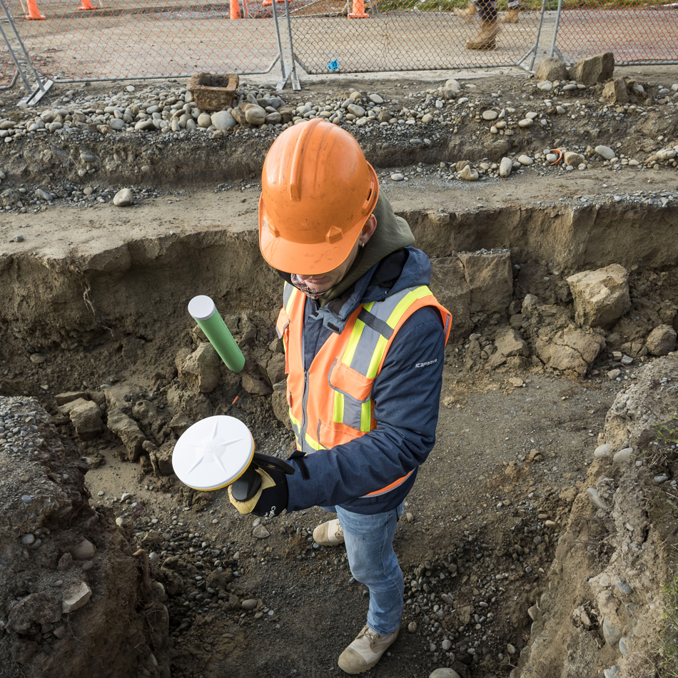 Surveyor in high-visibility vest using Trimble Catalyst with DA2 receiver