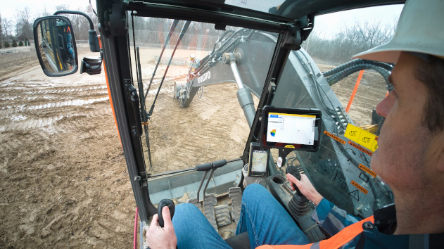 Construction worker in an excavator using Trimble siteworks on a tablet