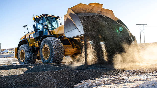 Wheel loader with Trimble Earthworks Grade Control tipping a bucket load of dirt