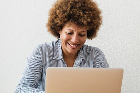 Dermatologist taking an online course on a laptop