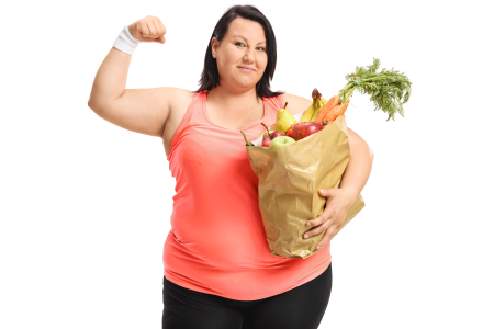 Overweight woman flexing her biceps and holding a bag full of healthy groceries