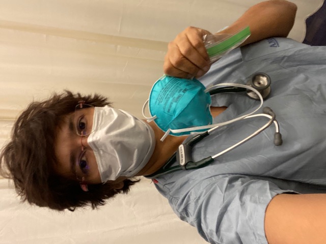 Dr. Nori dons PPE and a stethoscope while treating COVID-19 patients.