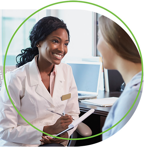 A female dermatologist discusses care with a female patient | American Academy of Dermatology (AAD).