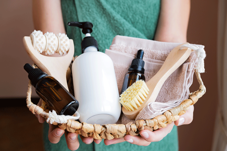 Woman holding large basket of self-care products