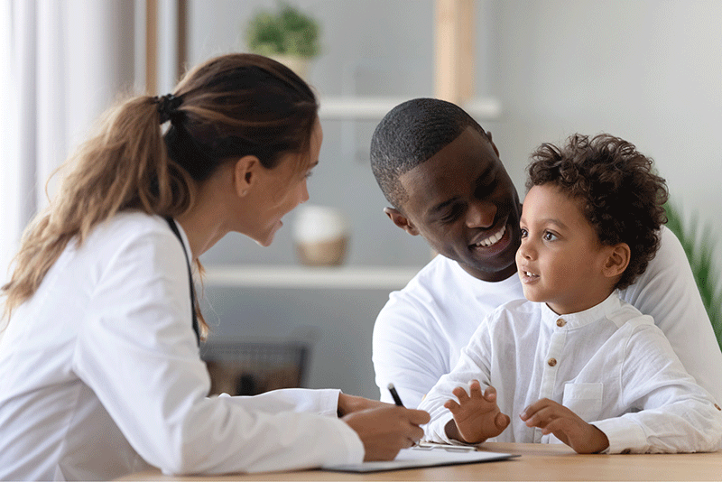 Photo of dermatologist talking to father and son in AAD's Diversity, Equity, and Inclusion initiative support page