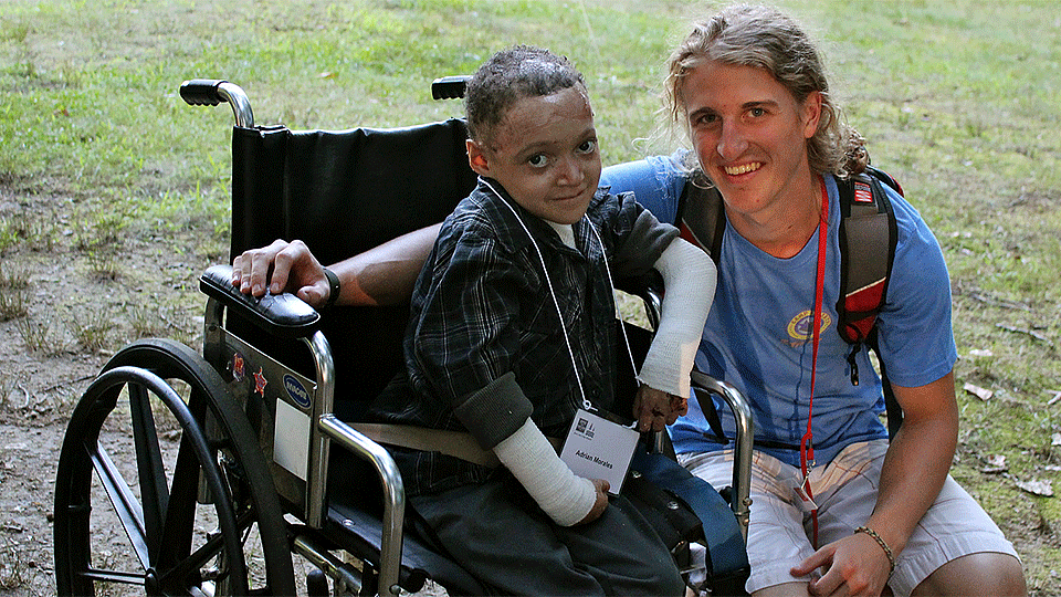 An AAD Camp Discovery camp participant with a camp volunteer