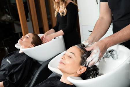 Women getting hair washed at salon