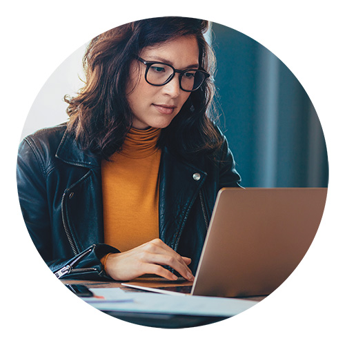 Female young physician dermatologist working on compliance policies on her laptop | American Academy of Dermatology (AAD).
