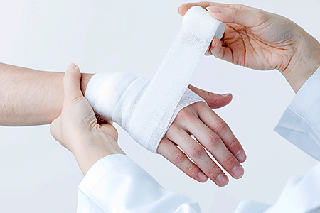 Dermatologist treating wound for person with diabetes