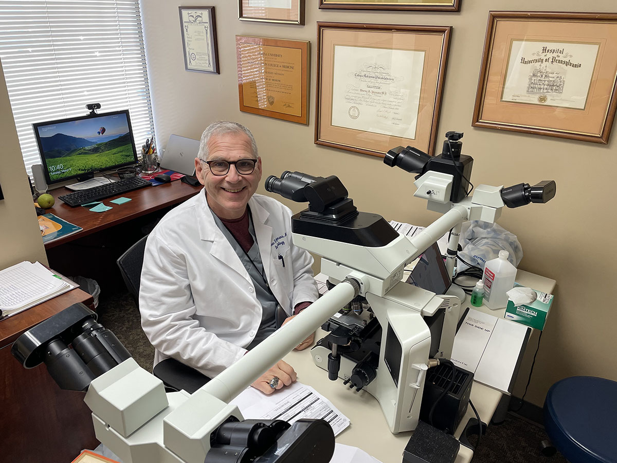 Image of Dr. Heymann at microscope