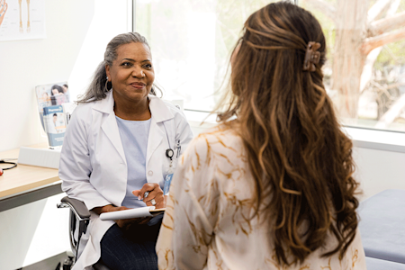 Dermatologist gives advice to patient about gray hair during appointment