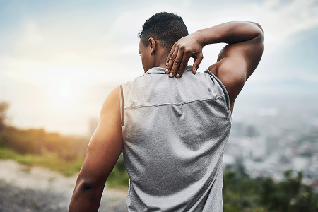 Black man reaching to scratch the back of his neck