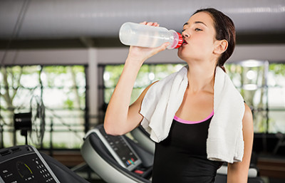 Woman at gym drinking water
