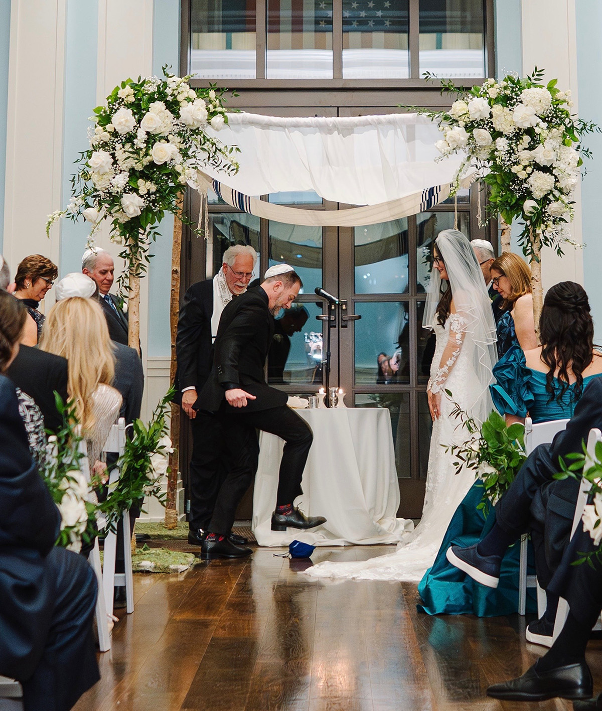 Son in law and daughter of Dr. Heymann stepping on the glass as part of their wedding ceremony | American Academy of Dermatology (AAD).