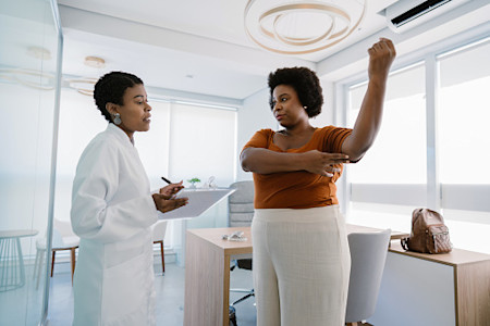 Dermatologist and patient reviewing a treatment plan for hidradenitis suppurativa