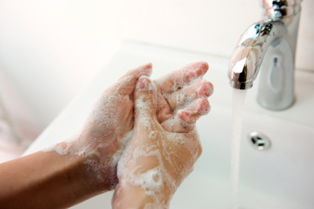 Washing hands with soap under running water