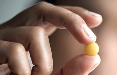 person holding pill