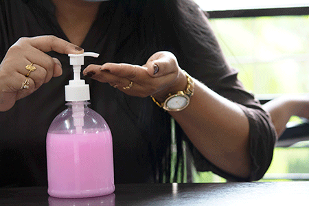 Woman pumping soap onto hand 