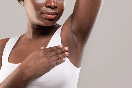 Women raises arm due to pain in her armpit