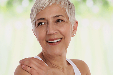 Smiling mature woman looking over her shoulder