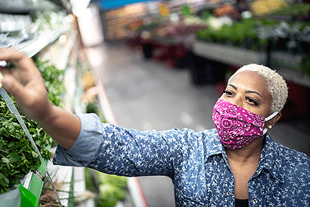 Woman wearing face mask while shopping
