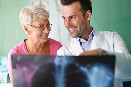 Male doctor reviewing x-ray results with female patient