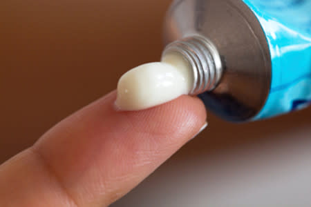 Close-up of cream on tip of finger