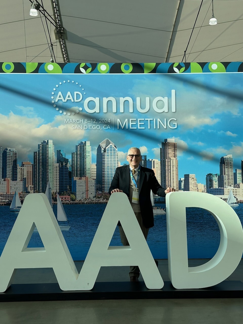 Warren R. Heymann, MD, FAAD, poses at the ever-popular photo opportunity in the Sails Pavilion in the San Diego Convention Center