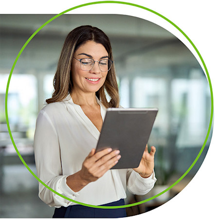 Businesswoman holding tablet as she works through practice management issues.