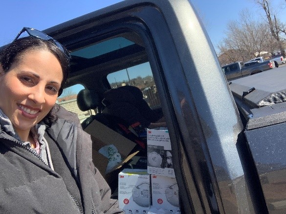 Dr. Farah collects PPE supplies in her car.