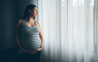 pregnant woman looking out window