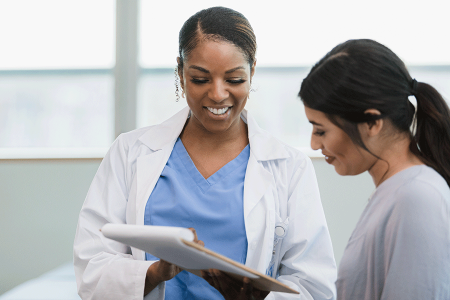 Dermatologist showing patient printed information about biosimilars