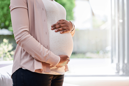 pregnant woman with hands on belly