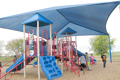 Shade structure protecting playground equipment