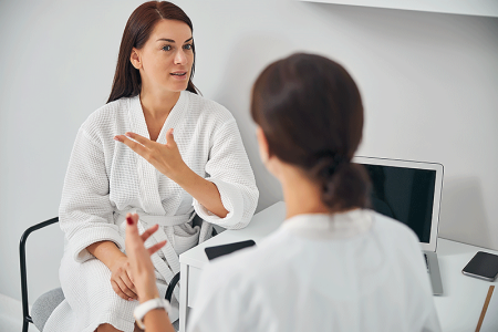 Female patient talking to her dermatologist